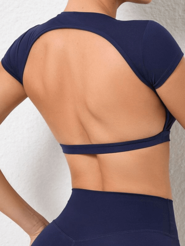 Fashionable cropped women's top with open back, elastic design, and short sleeves, perfect for yoga. Made from durable nylon.